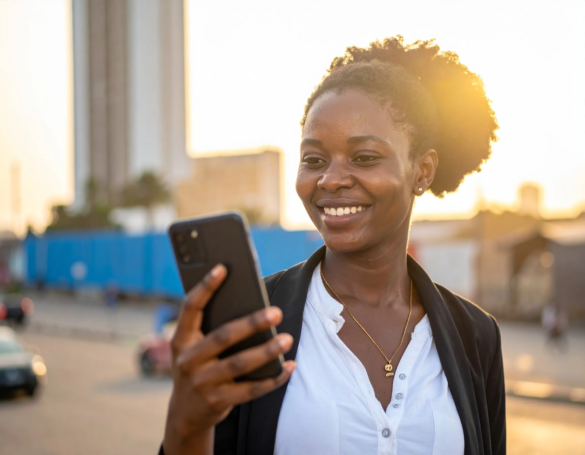 Woman holding phone outdoors